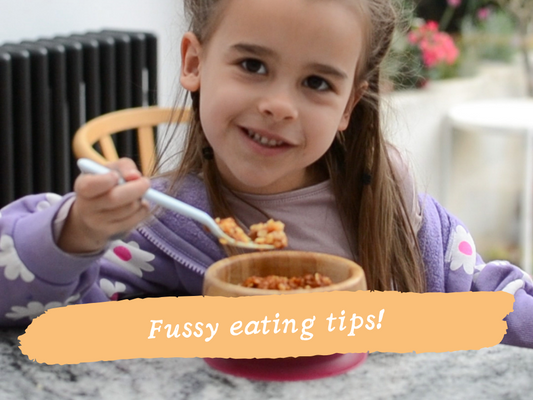 Toddler having a tantrum with pasta on her head